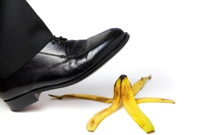 man's foot about to slip on banana peel